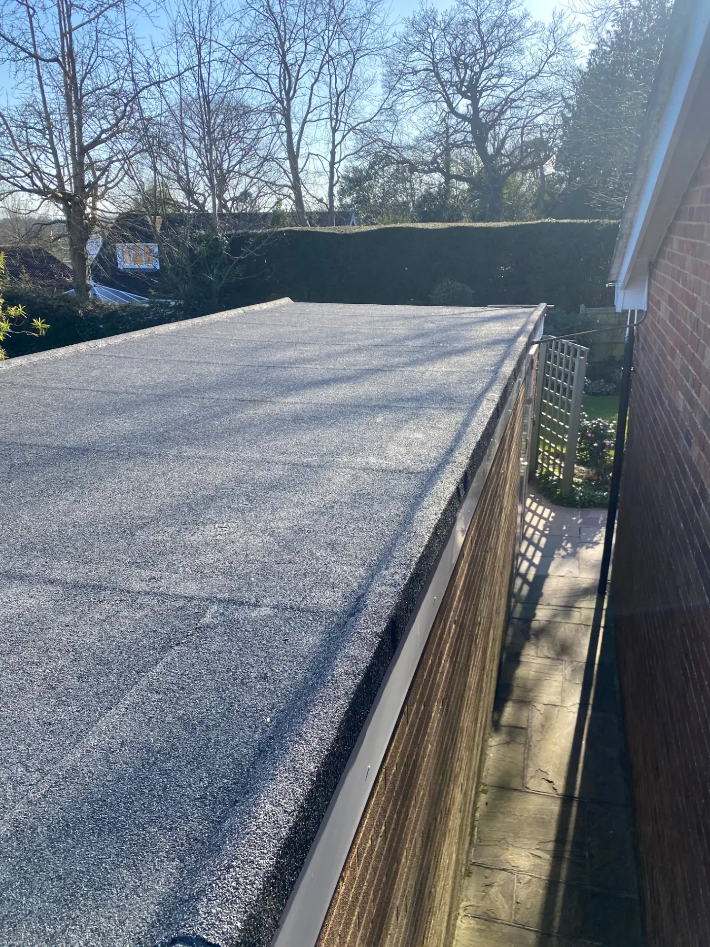 New torch-on felt flat roof with grey mineral finish